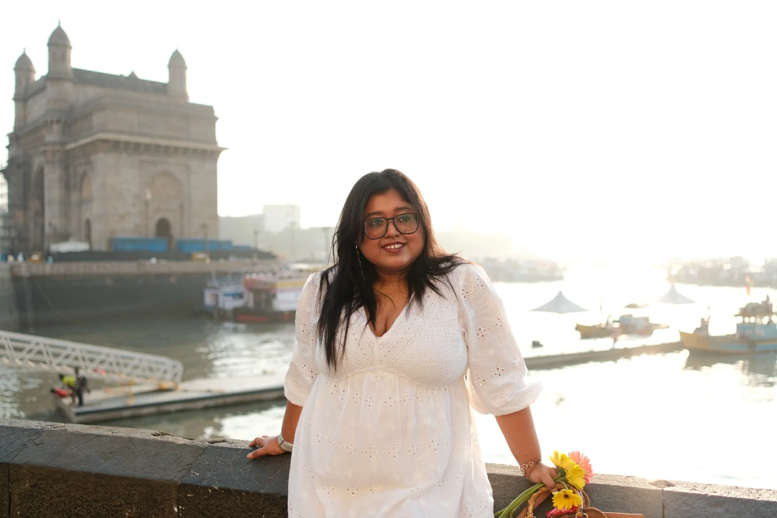 Esha Roy standing outdoors by the waterfront