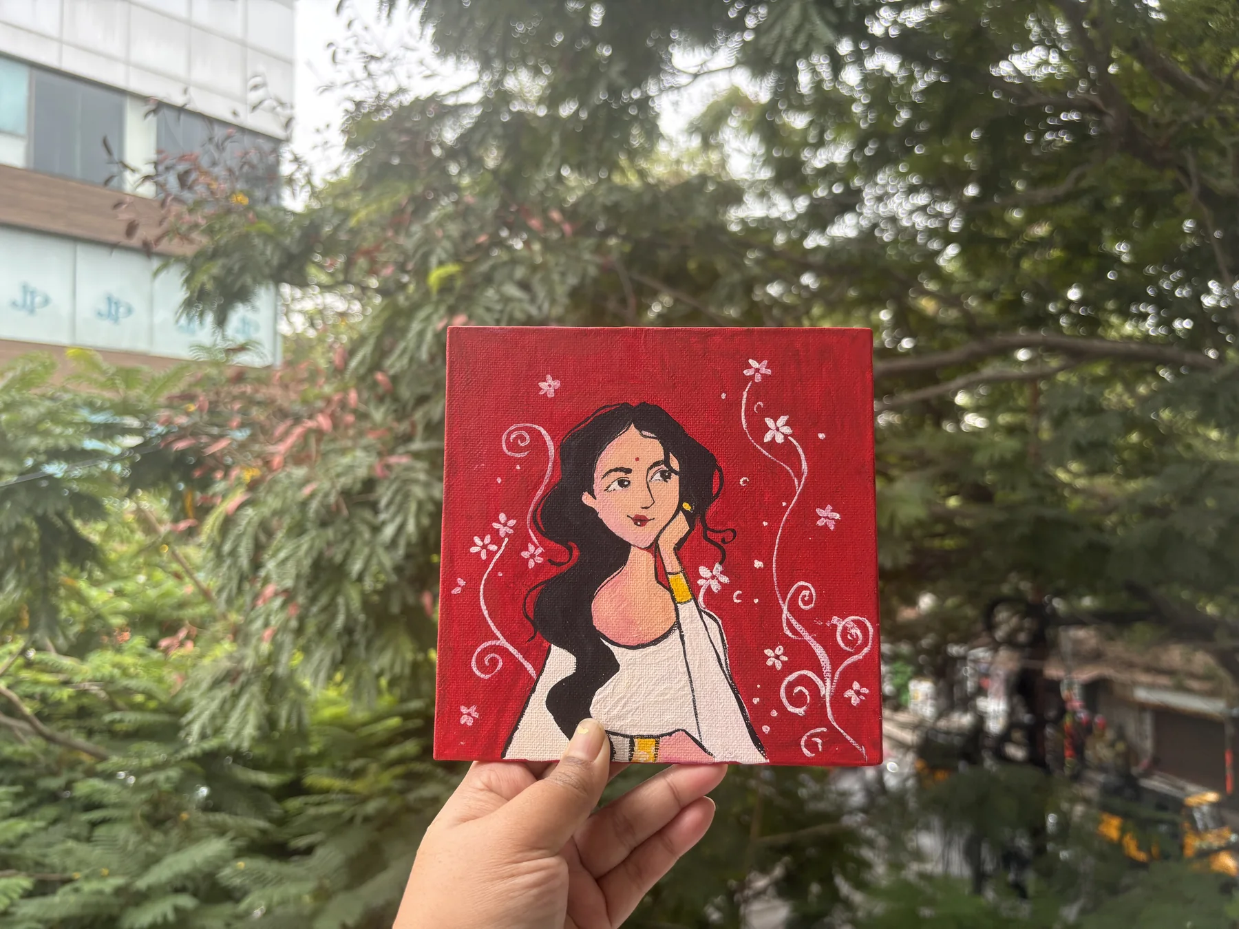Hand-painted portrait artwork on a red card